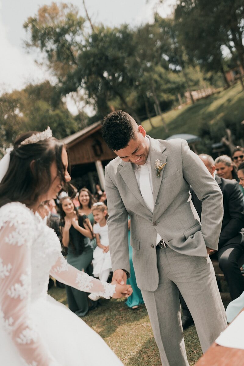 a bride and groom holding hands at a wedding ceremony
